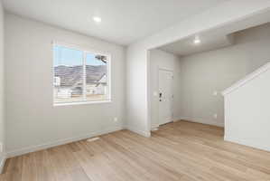 Spacious interior room with wood-finish flooring