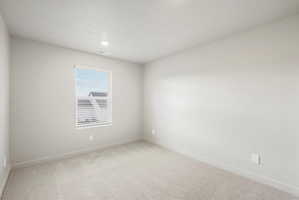 Neutral tone interior room featuring a window with white blinds