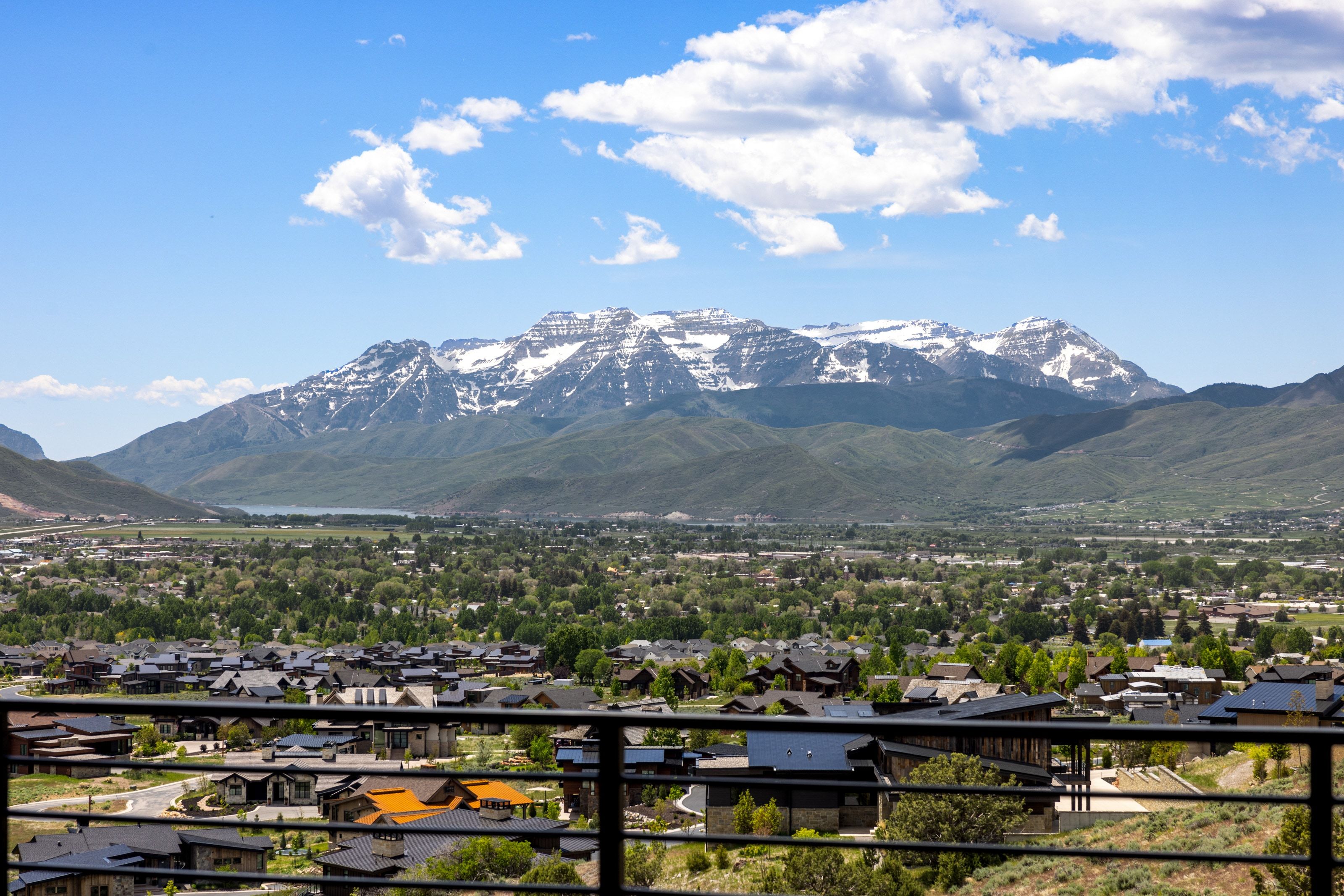 Expansive mountain scenery featuring snow-capped peaks and a valley landscape
