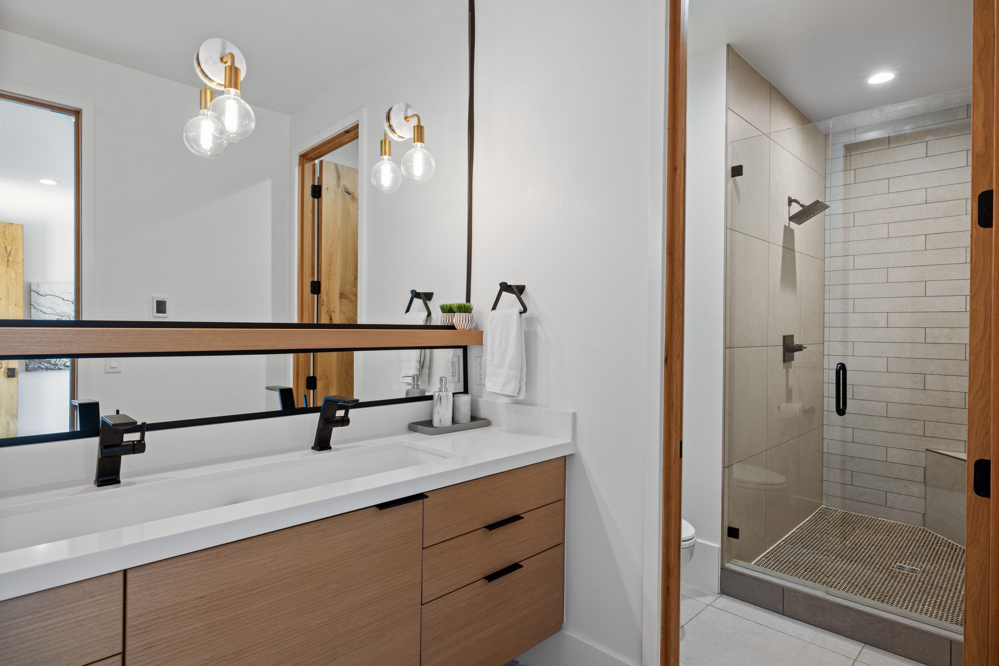 Dual vanity with integrated rectangular sinks, white countertop, and matte black fixtures