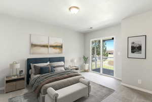 Neutral-toned bedroom featuring wall-to-wall carpeting and a ceiling-mounted light fixture