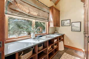Expansive wood-framed window with a deep sill, providing generous natural light