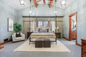 Vaulted ceiling with exposed wood beams and central ceiling fan