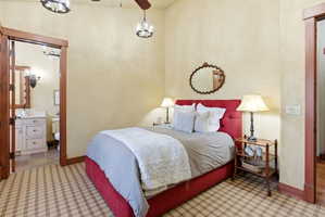 Room featuring plaid carpet, light-toned walls, and wood trim