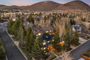 Aerial perspective of a neighborhood featuring residential properties and mature trees