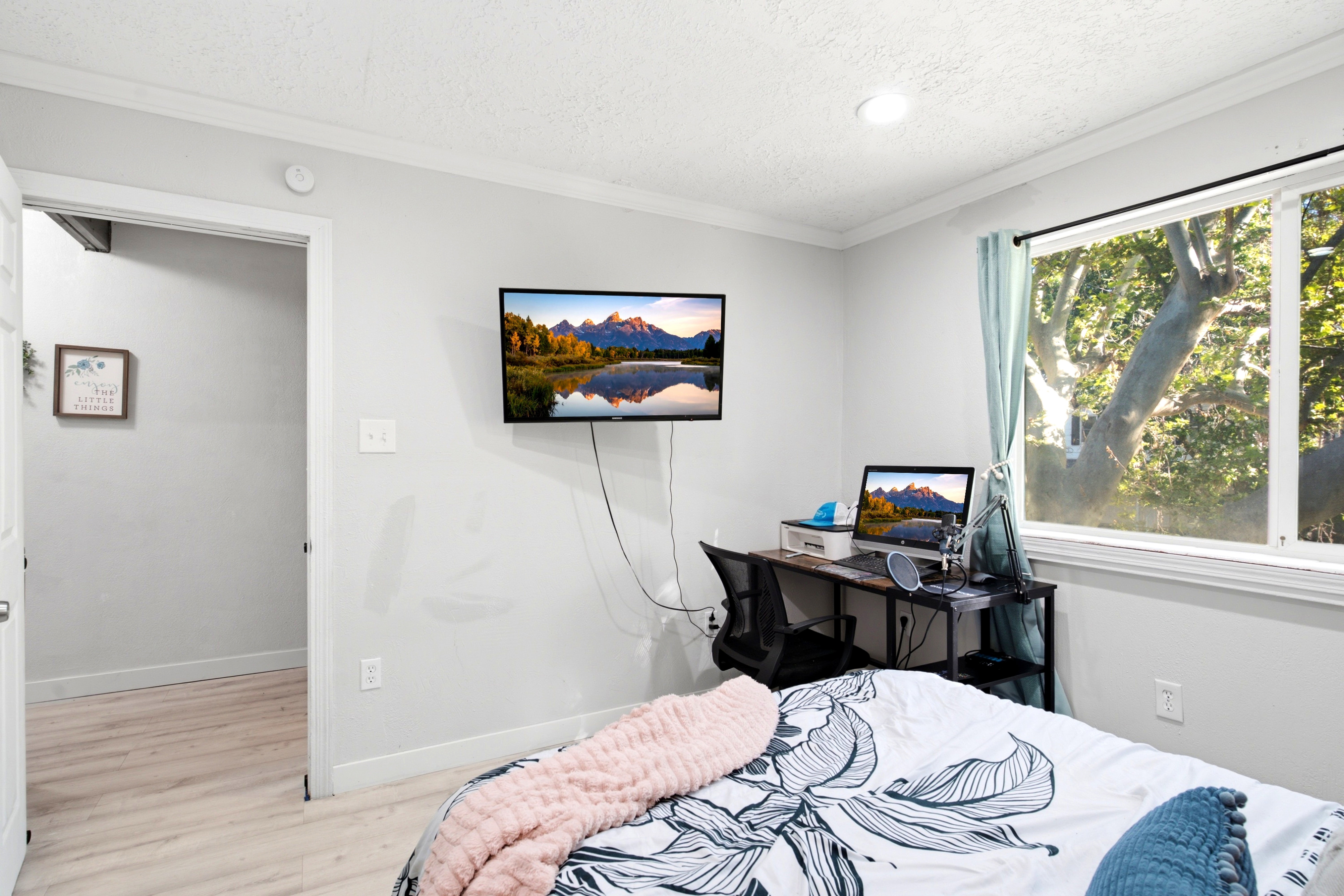 Room with light wood-finish flooring, white walls, and a recessed ceiling light