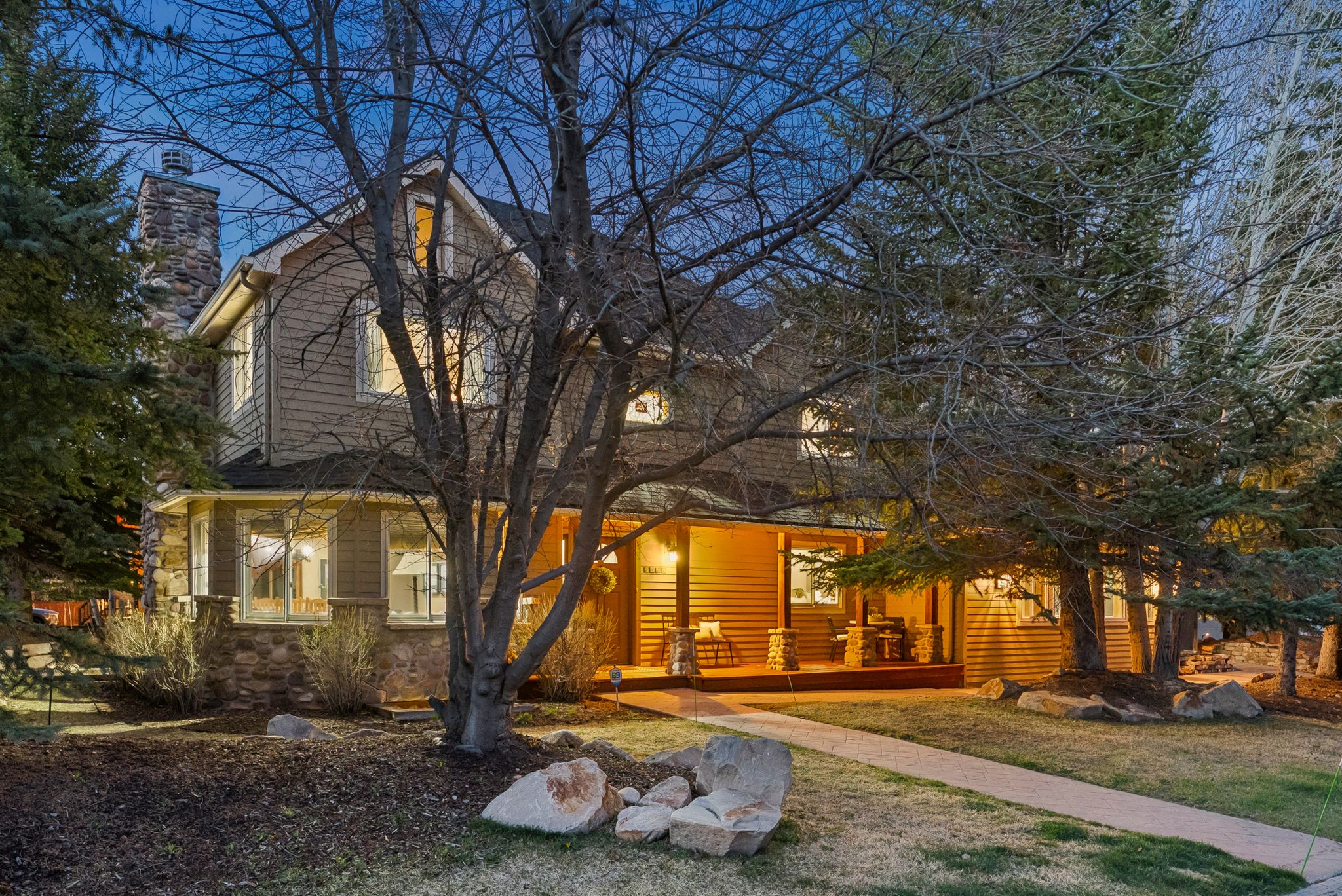 Property exterior featuring multi-level siding and stone accents