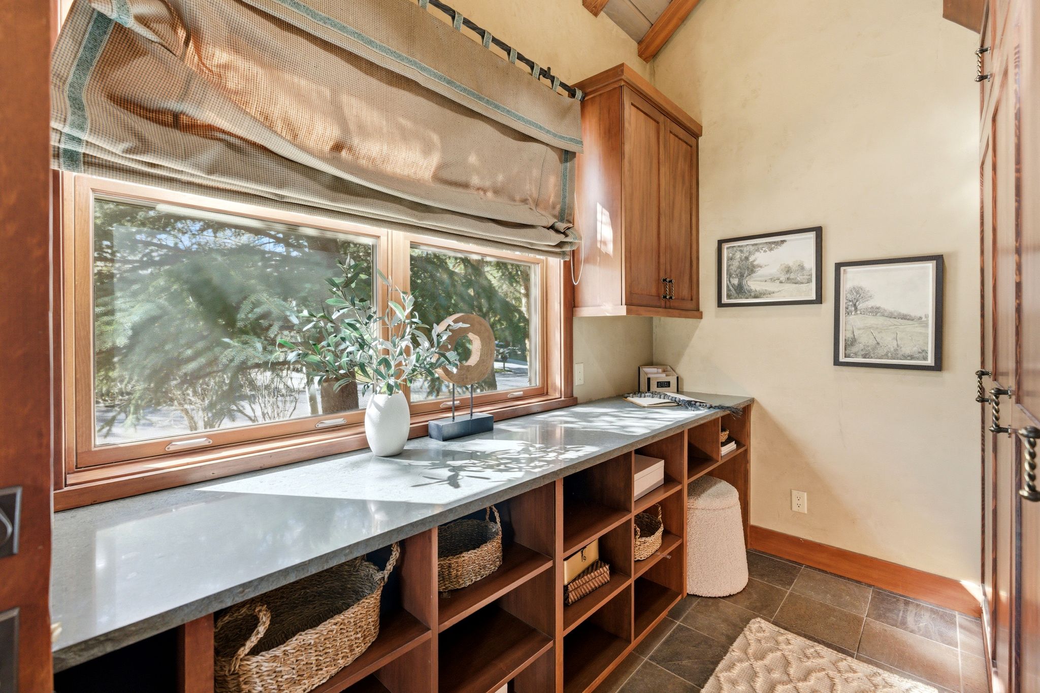 Expansive wood-framed window with a deep sill, providing generous natural light