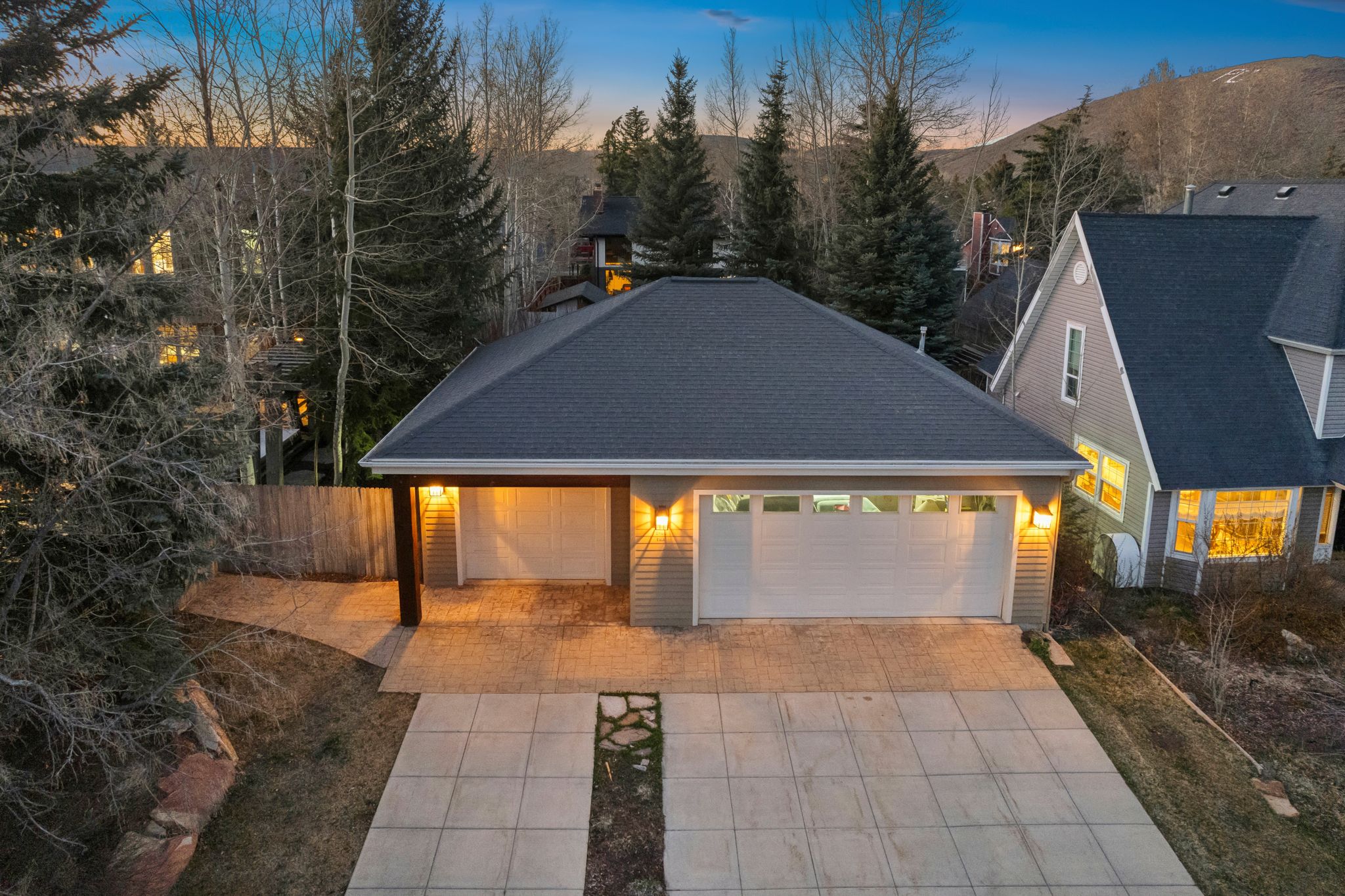 Single-story residence featuring a dark gray shingle roof and light gray horizontal siding