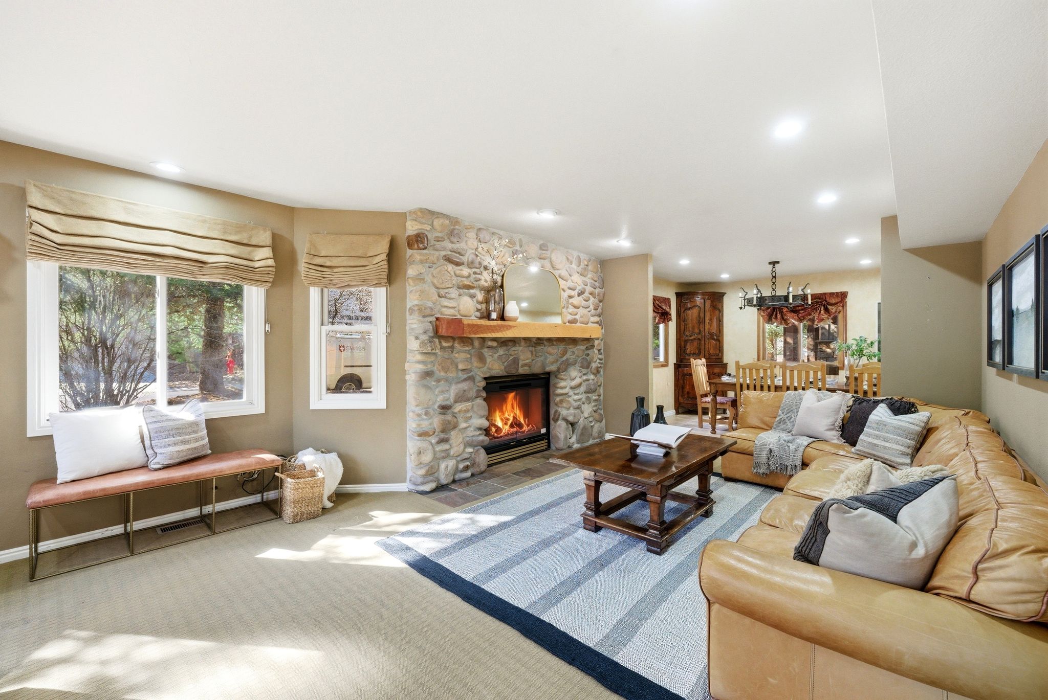 Stone-clad fireplace with a substantial wood mantel