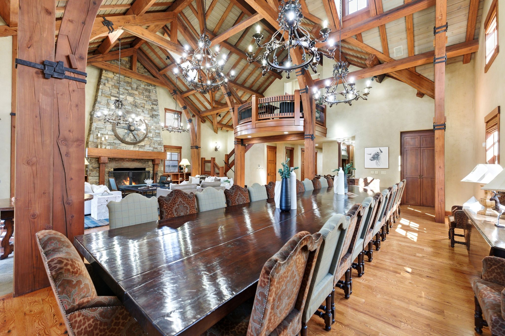 Spacious dining area featuring a large, polished wood table and hardwood flooring