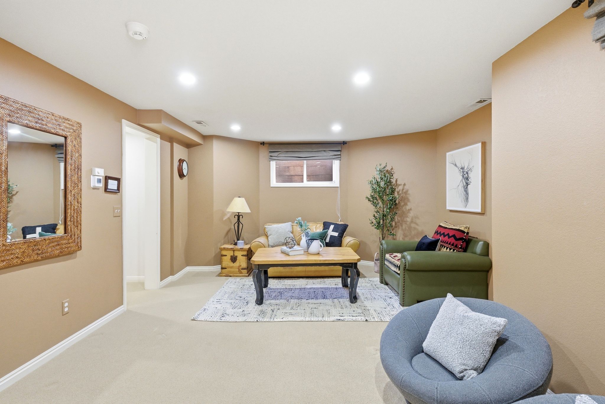 Carpeted common area featuring recessed lighting, a single window with blinds, and light beige wall finishes