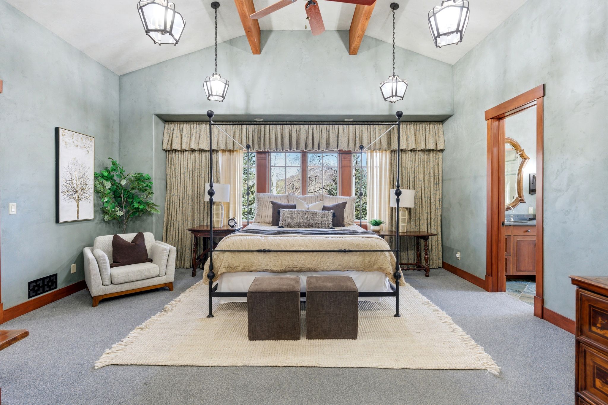 Vaulted ceiling with exposed wood beams and central ceiling fan