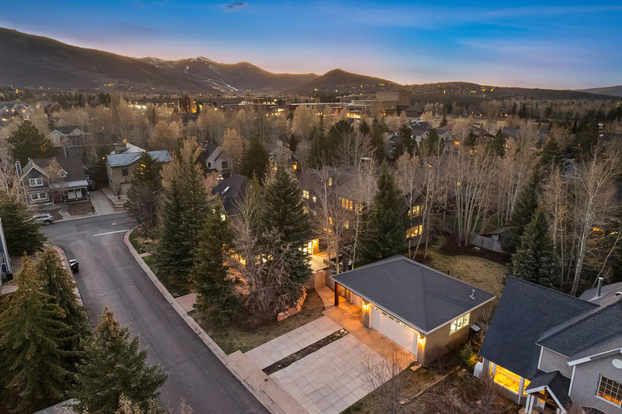 Aerial overview showcasing a two-story residence with a paved driveway and an attached two-car garage