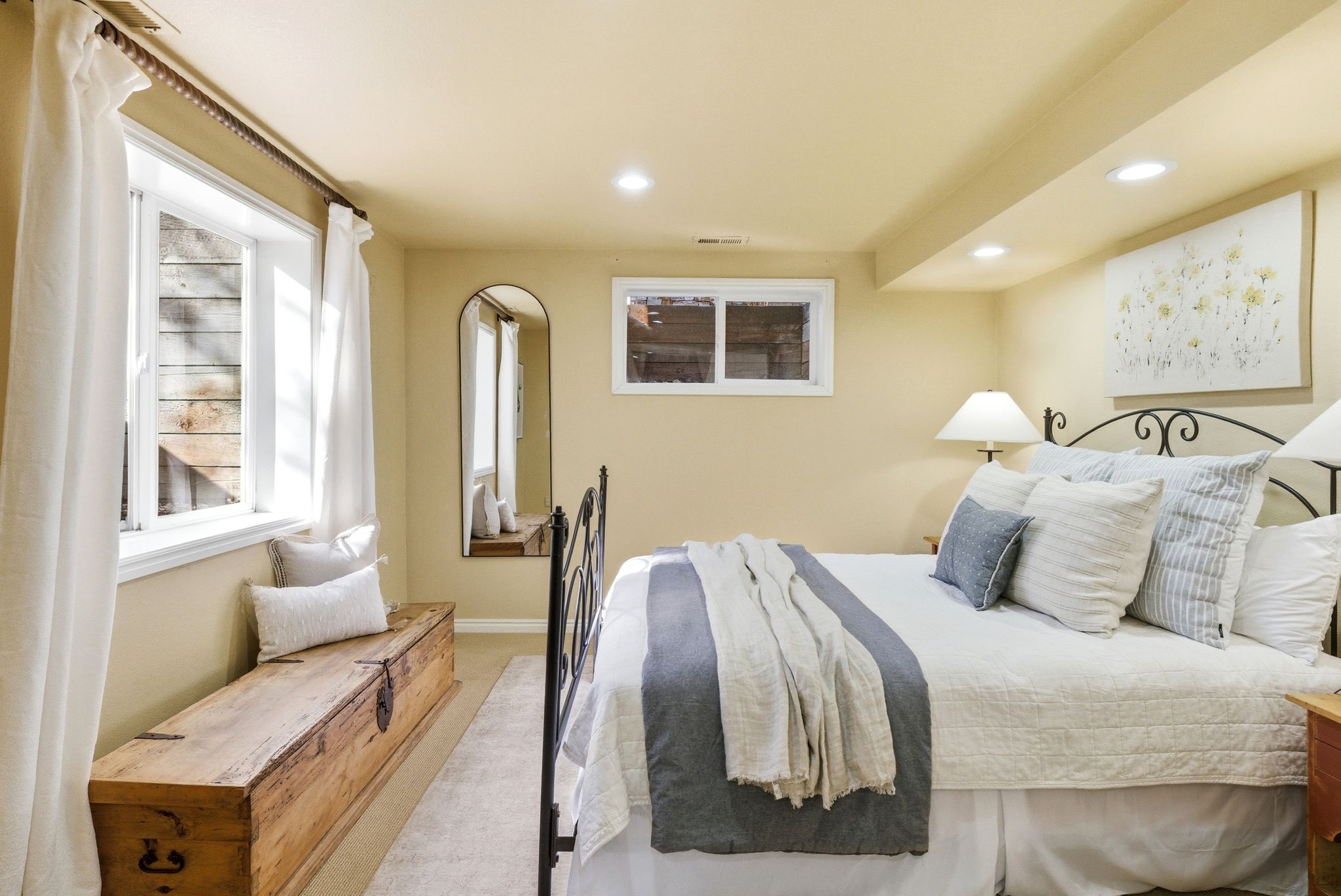 Recessed lighting illuminates this room, featuring light-toned walls and carpeted flooring