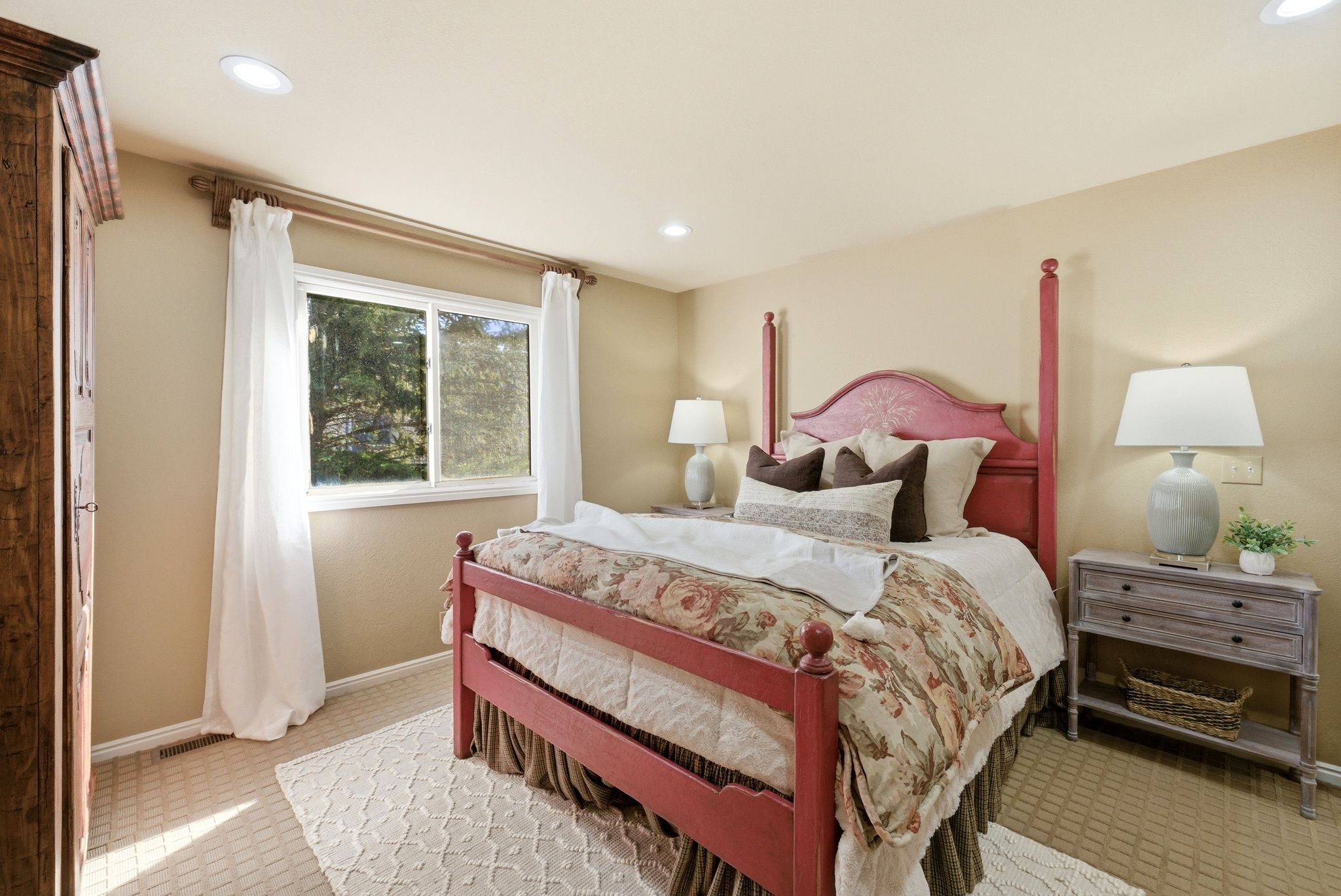 Recessed lighting illuminates neutral-toned walls and textured carpeting