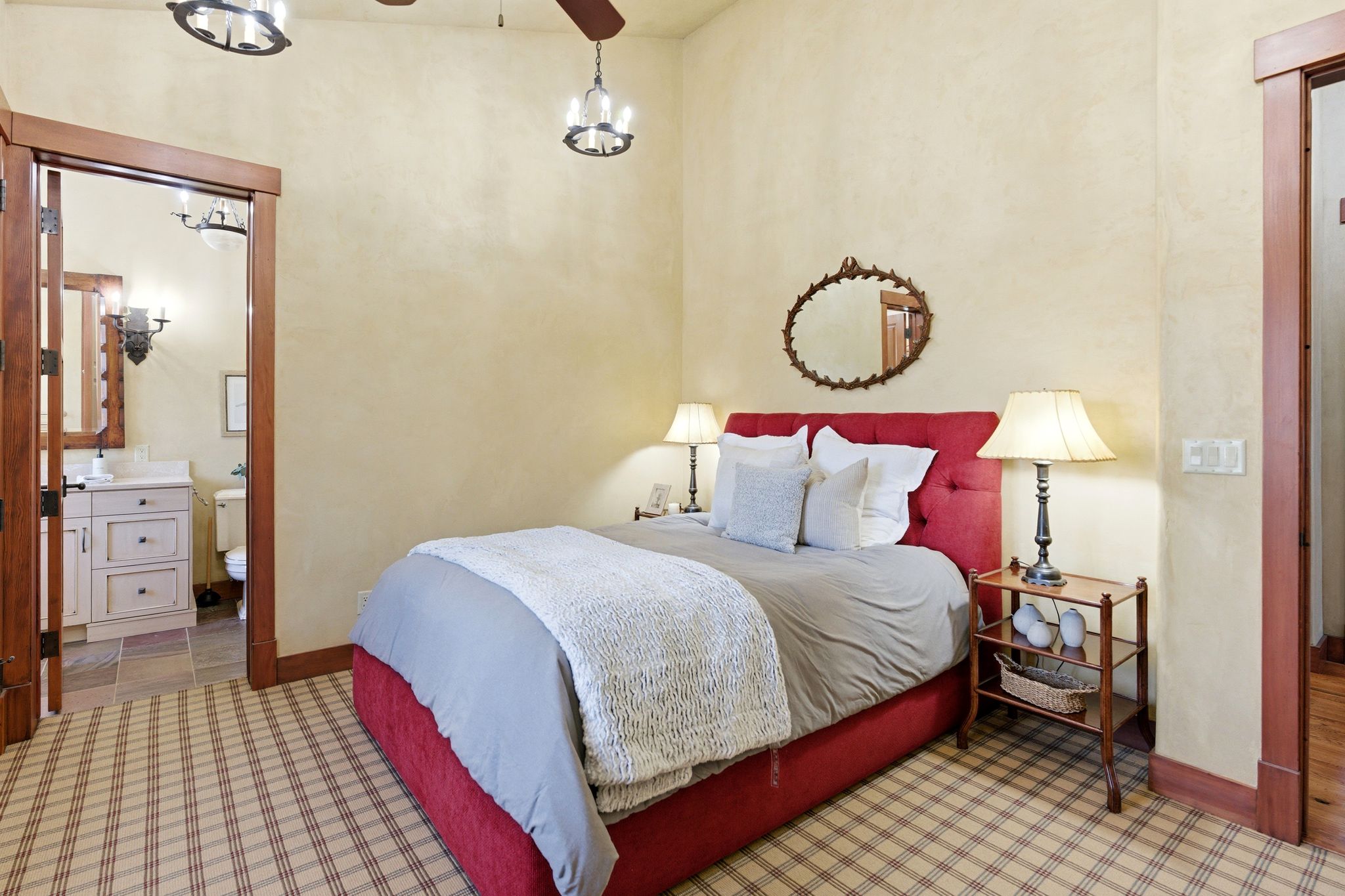 Room featuring plaid carpet, light-toned walls, and wood trim