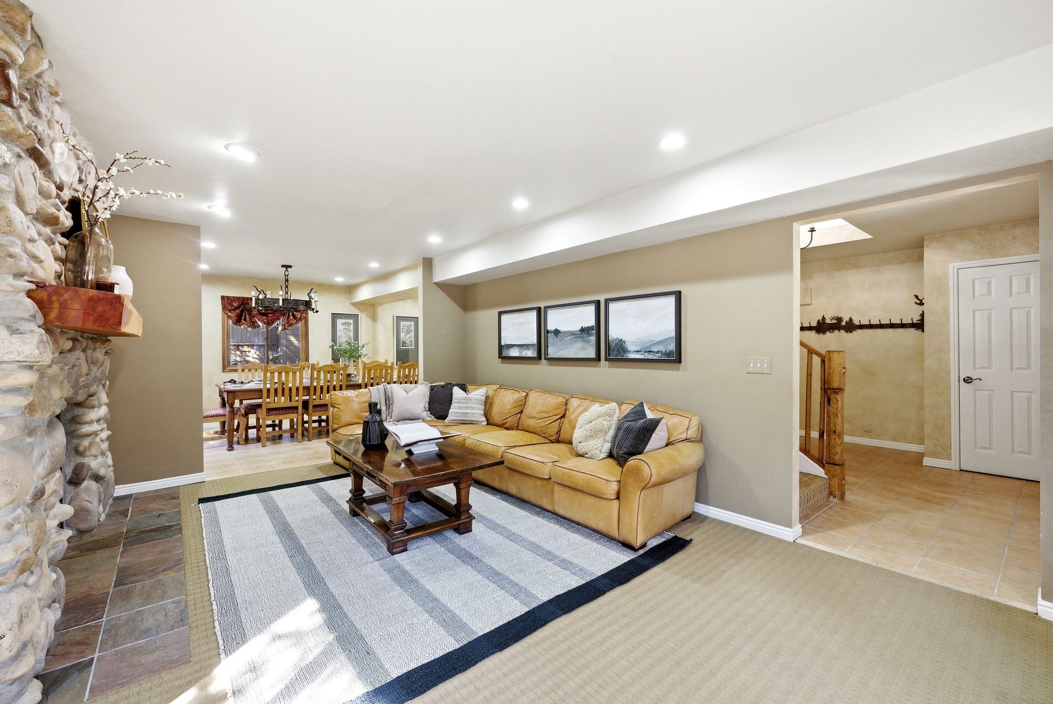 Living area featuring a stone fireplace with a wood mantle