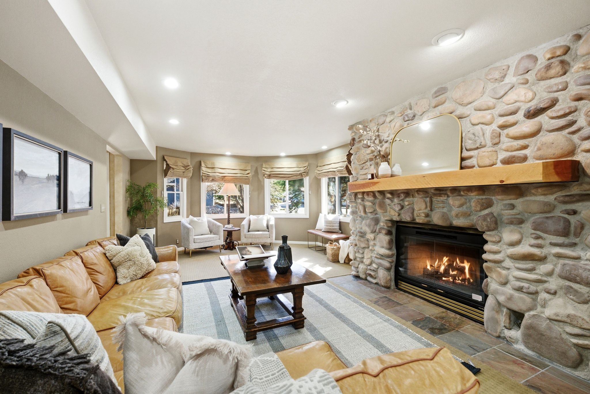 Stone-clad fireplace with wood mantle and hearth