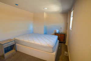Carpeted room featuring light-toned walls and a single window with blinds