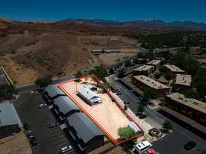Expansive lot outlined in red, featuring a single-story structure with a metal roof