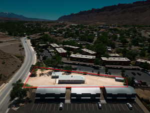 Expansive property featuring a flat, cleared lot, two existing structures, and proximity to a paved road