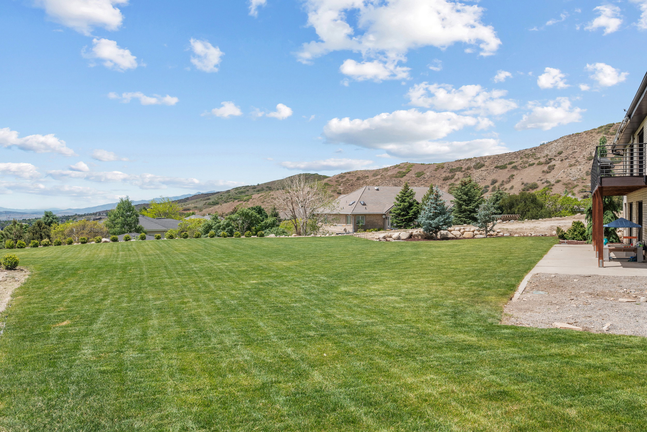 Expansive level lawn area with mountain scenery