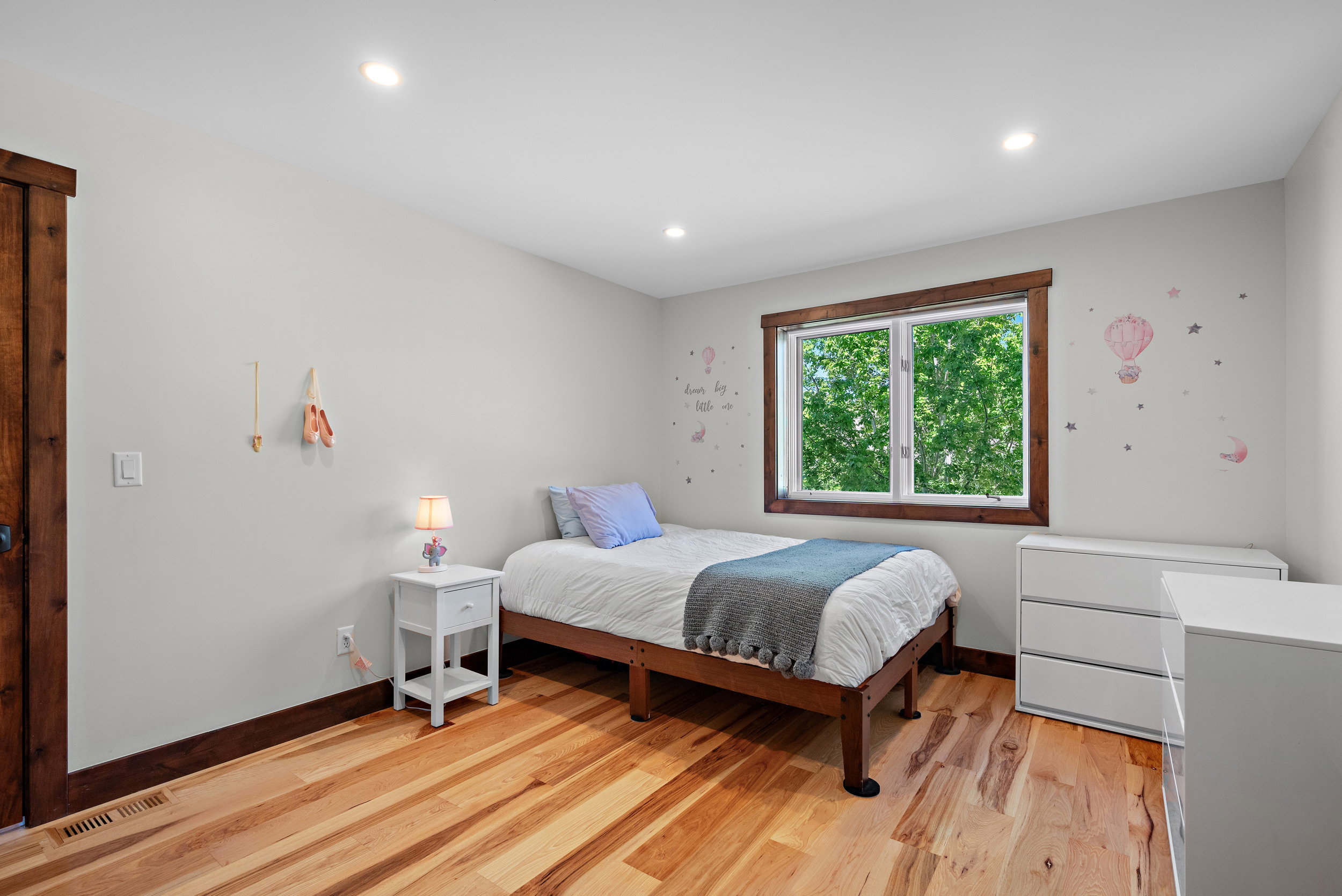 Bedroom featuring light-toned walls, recessed lighting, and wood-finish flooring