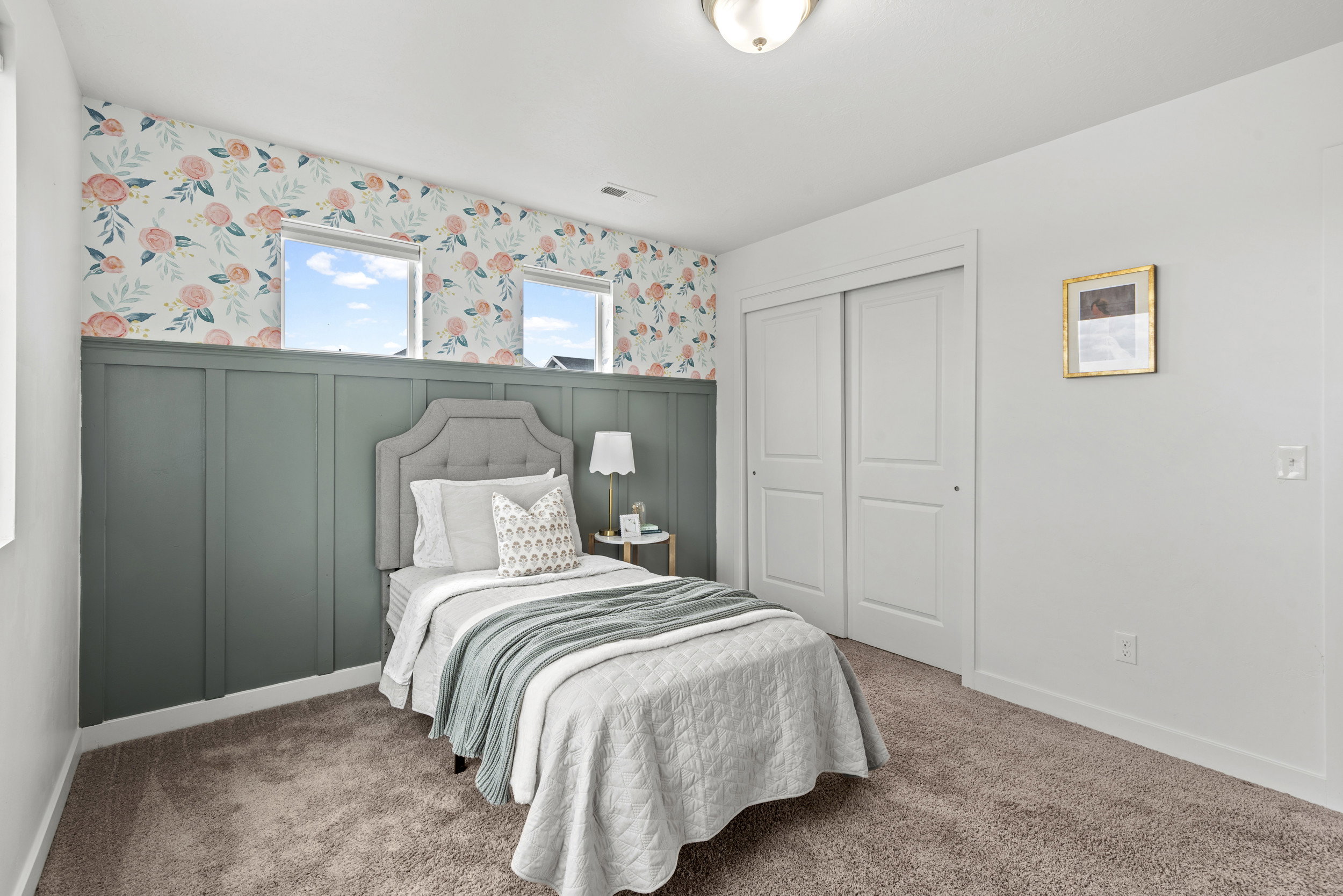 Room featuring decorative wainscoting and floral wallpaper