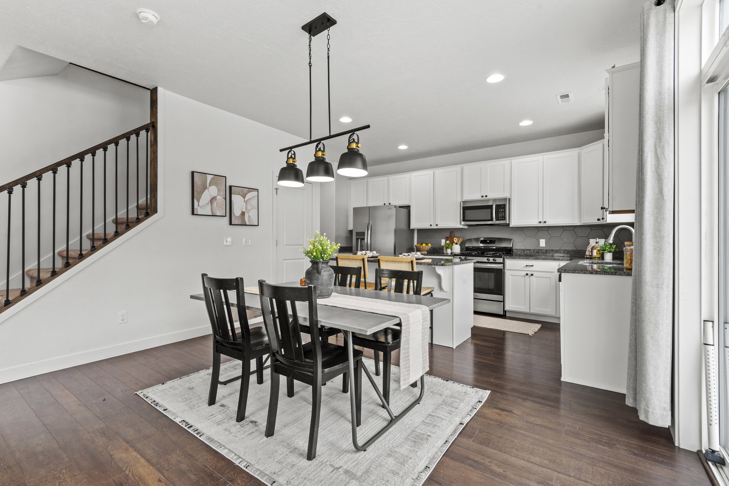 Open-concept living space with dark wood-finish flooring