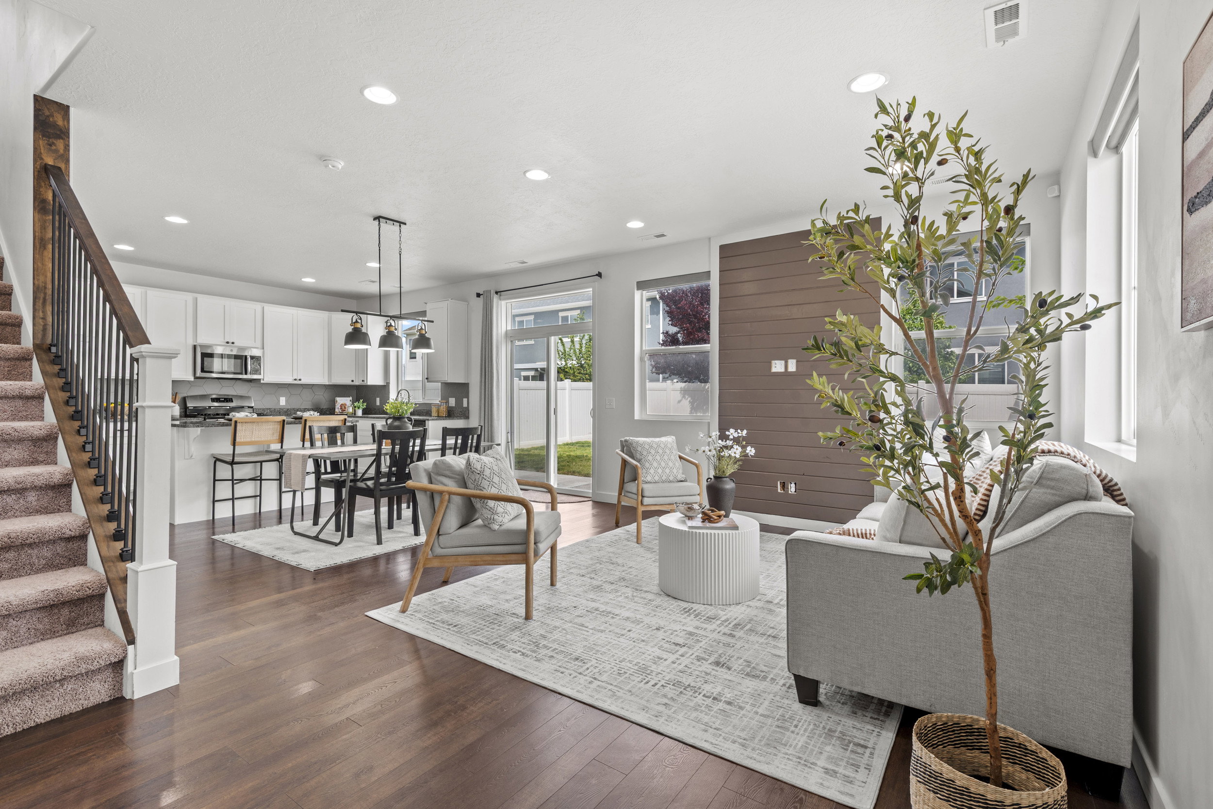 Open-concept living space with wood-finish flooring