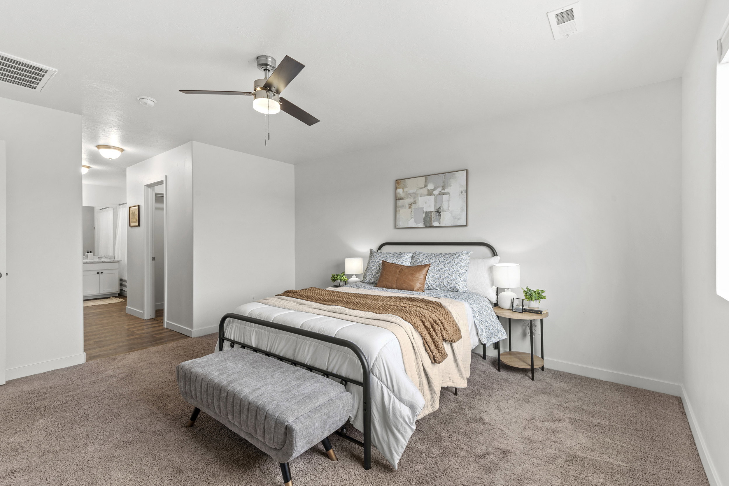 Bedroom featuring a ceiling fan with integrated lighting, window, and carpet flooring