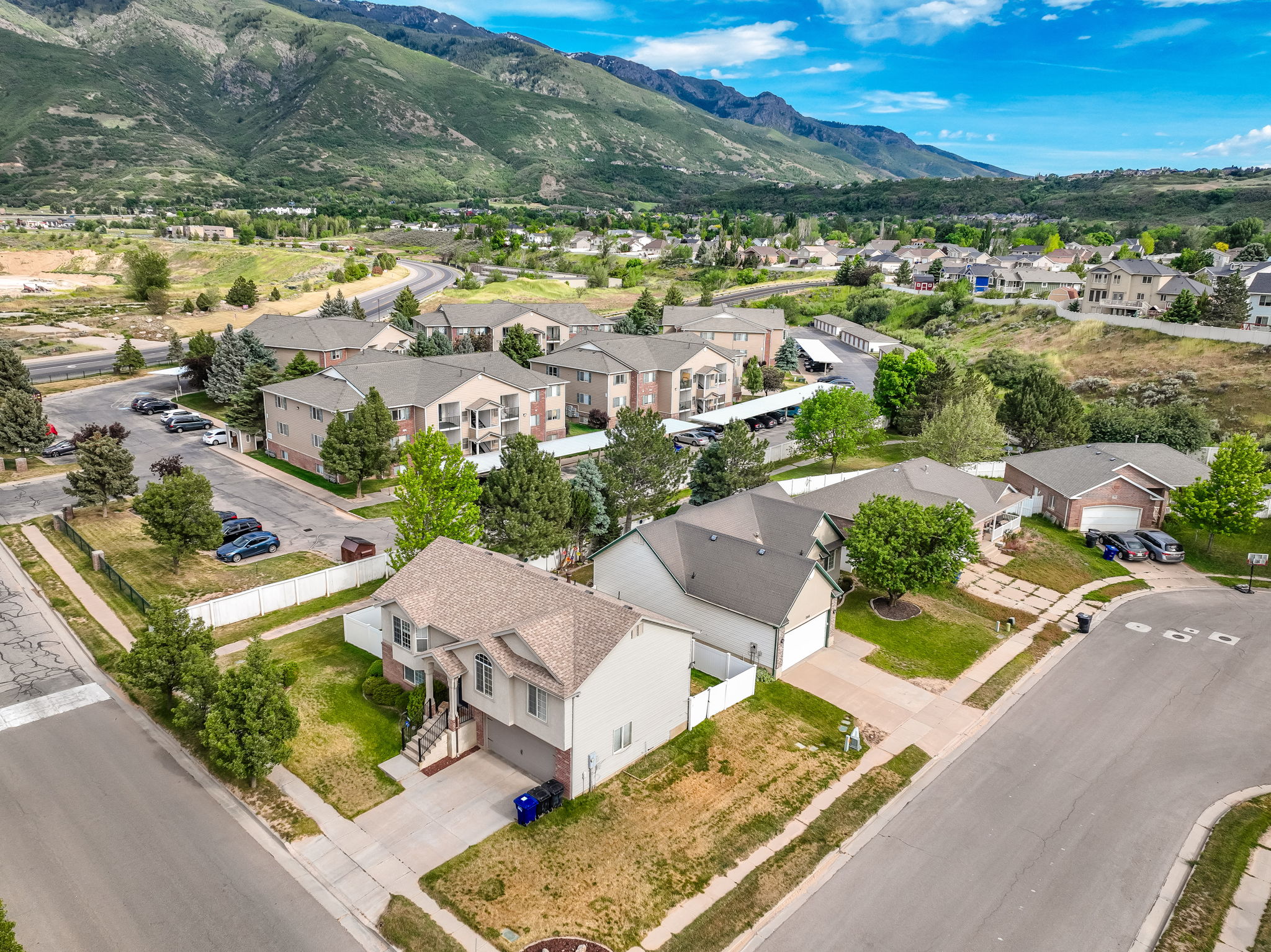 Two-story residence featuring a front entry staircase, an attached garage, and a driveway