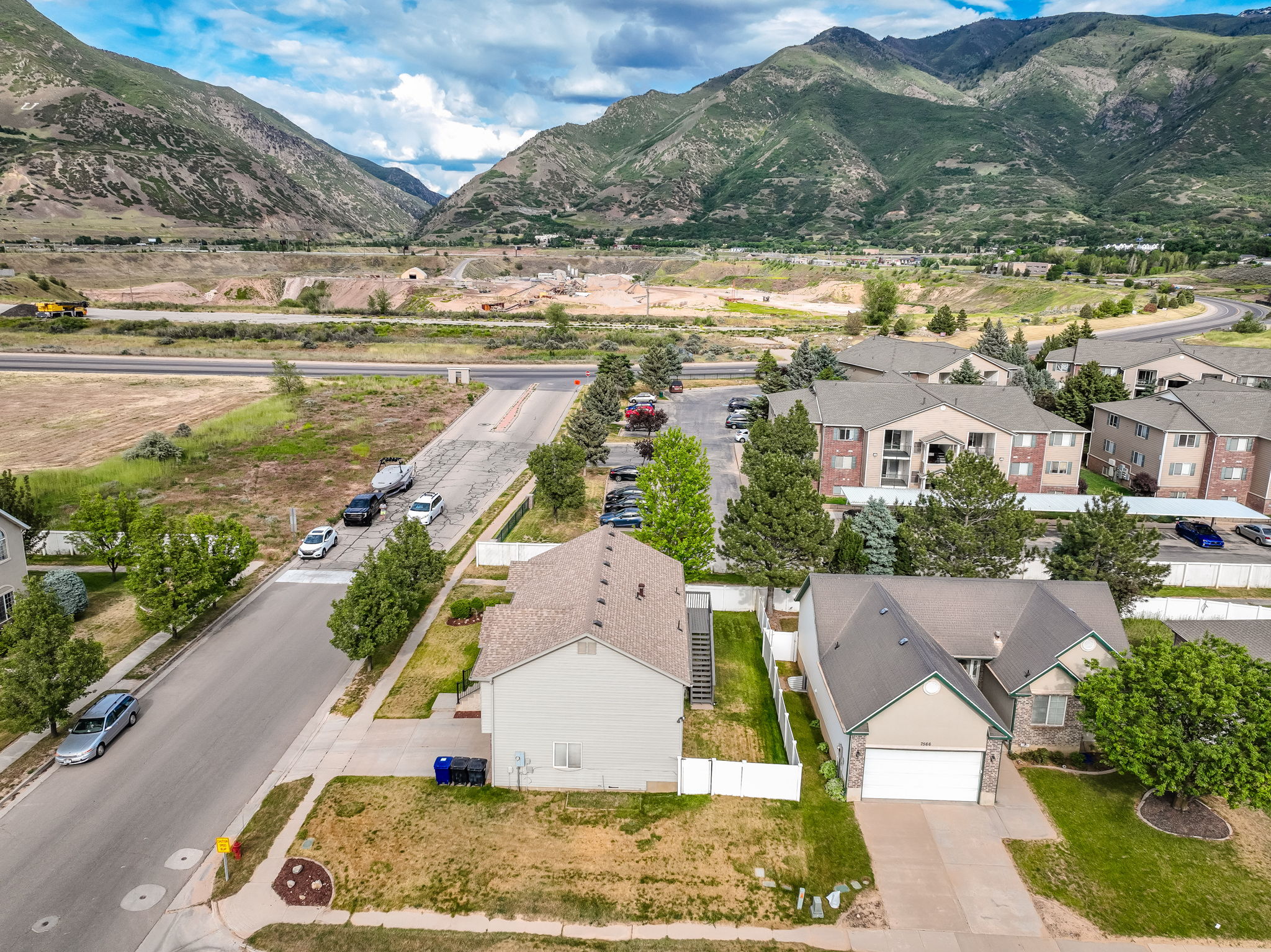 Drone perspective of a residential neighborhood with surrounding mountain scenery