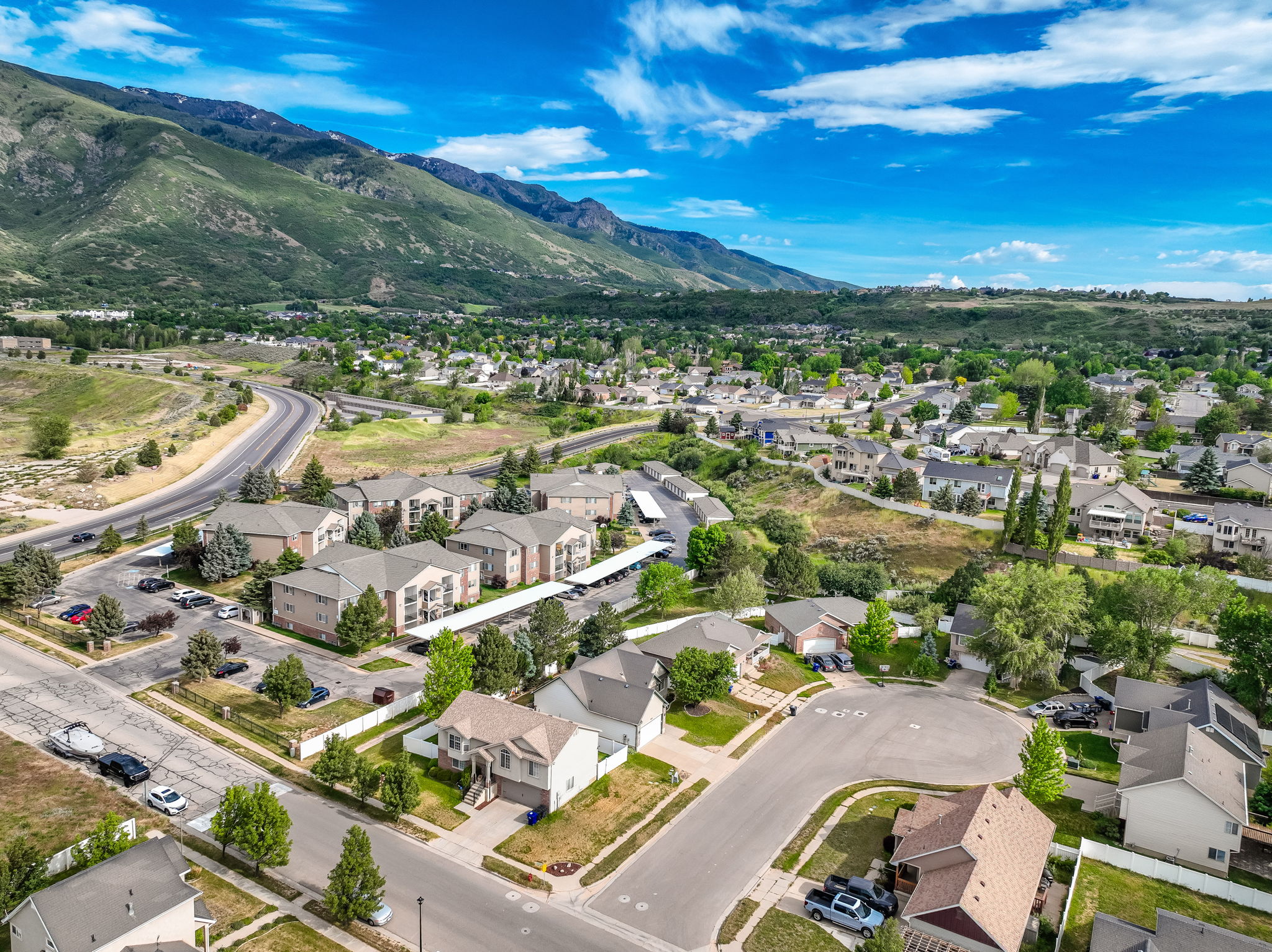 Aerial perspective showcasing a residential community with single-family homes and multi-unit buildings