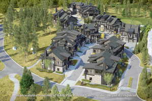 Contemporary mountain community featuring multiple residences with stone and wood-finish exteriors