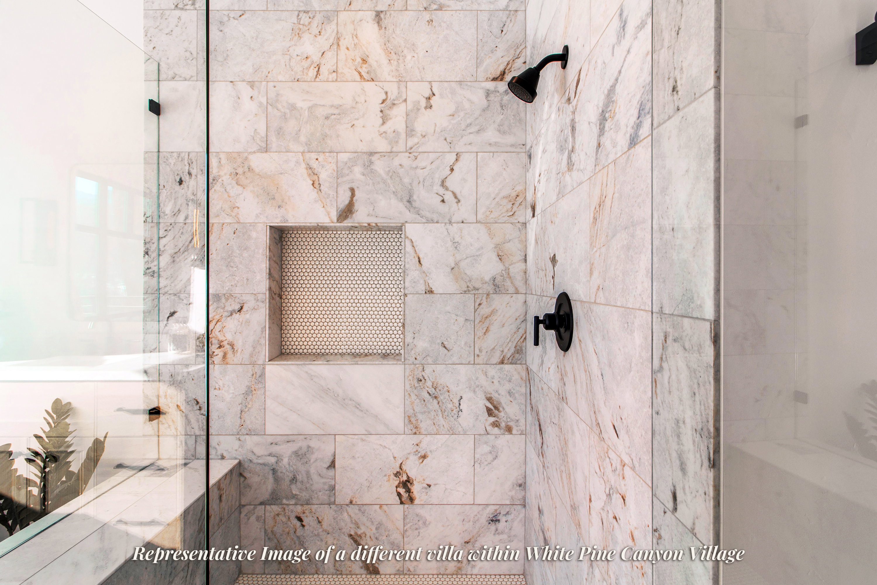 Shower enclosure featuring a frameless glass panel, large-format tile walls, matte black shower fixtures, and a recessed niche with penny tile