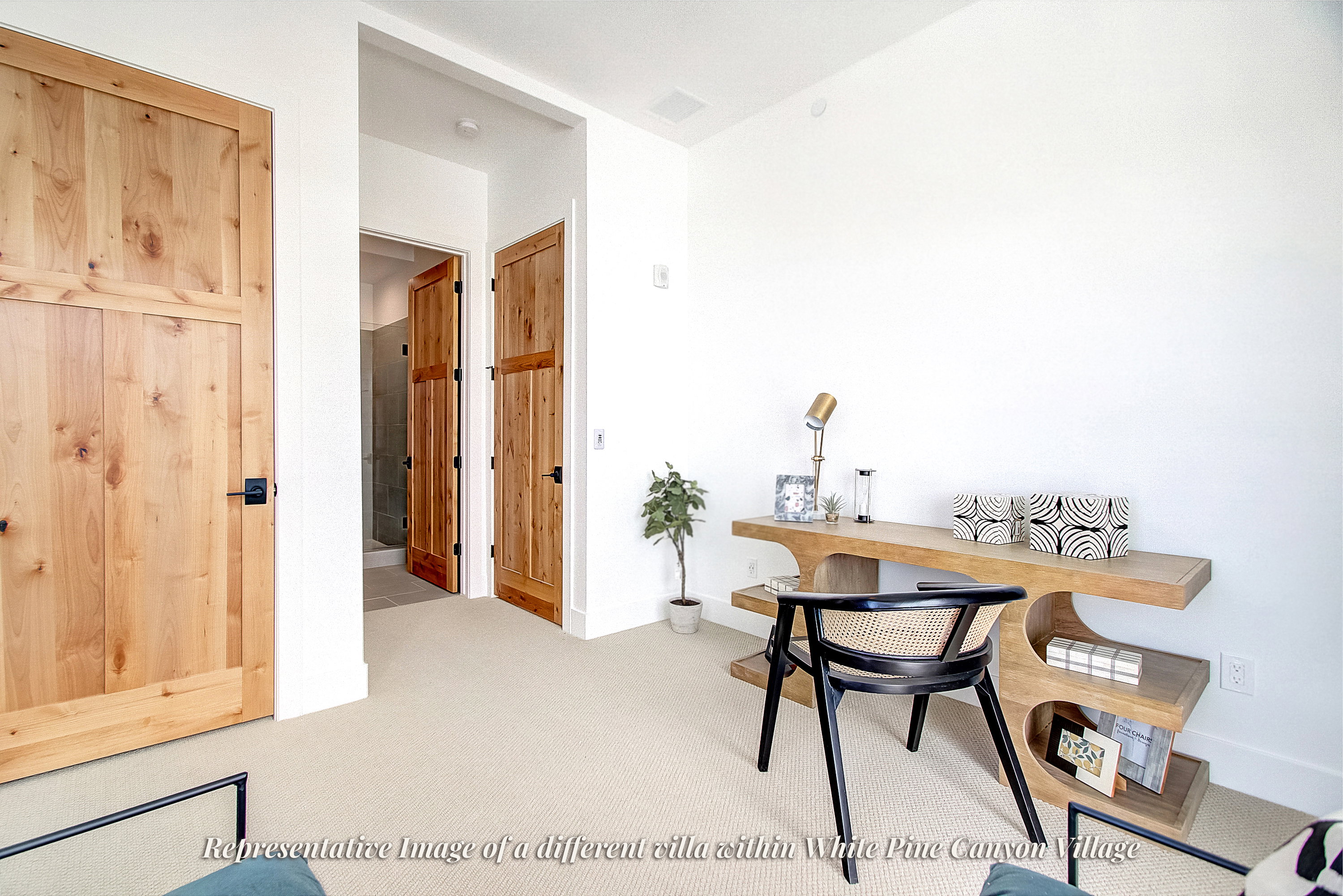 Neutral tone carpeting complements the clean white walls