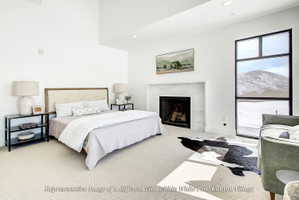 Spacious room featuring a central fireplace with a light-toned stone surround and herringbone-patterned firebox