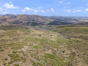 Expansive mountain terrain featuring rolling hills and distant peaks