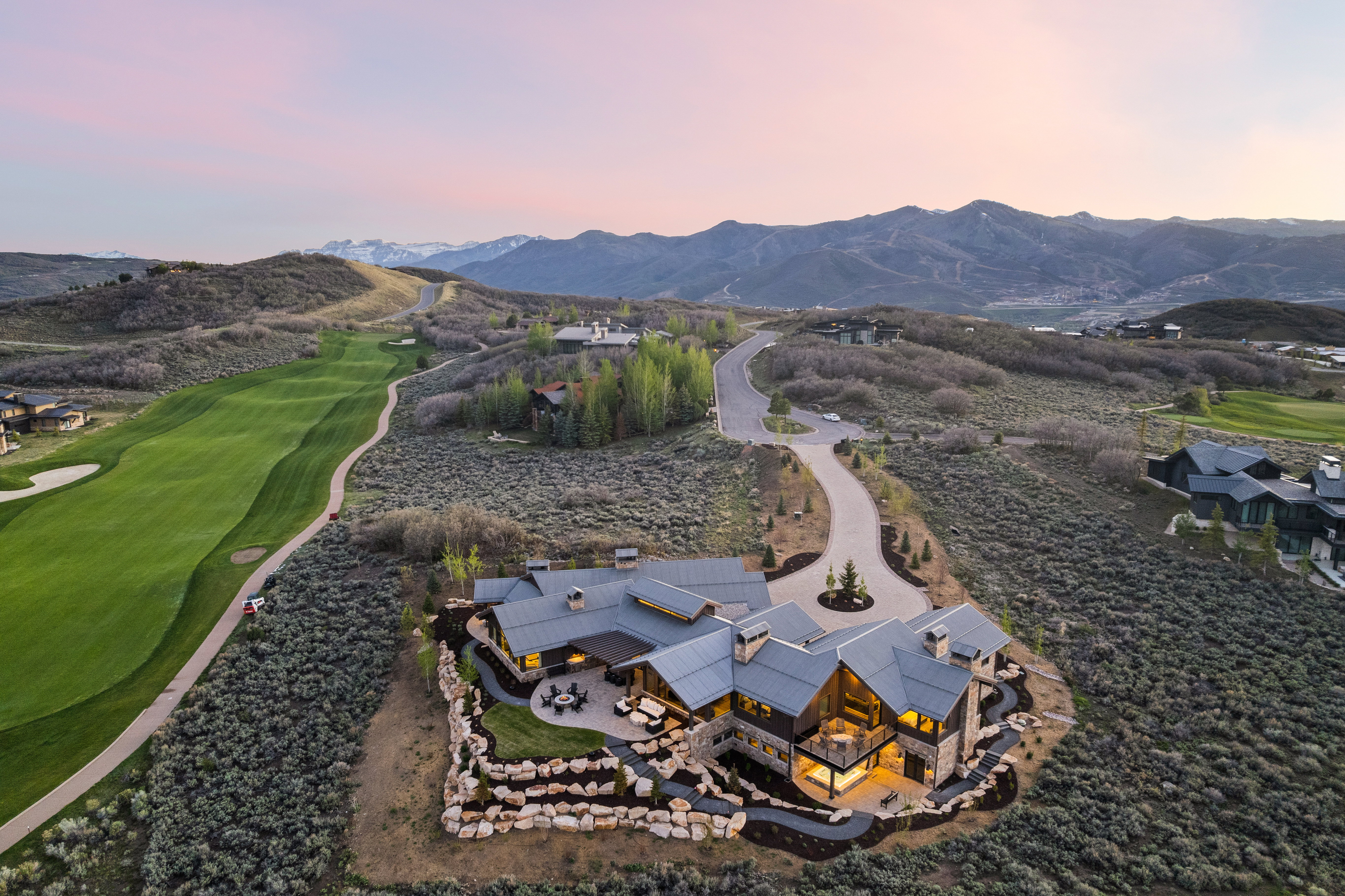Expansive mountain estate featuring a multi-level design, stone and wood exterior finishes, and multiple outdoor patios