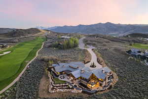 Expansive mountain estate featuring a multi-level design, stone and wood exterior finishes, and multiple outdoor patios