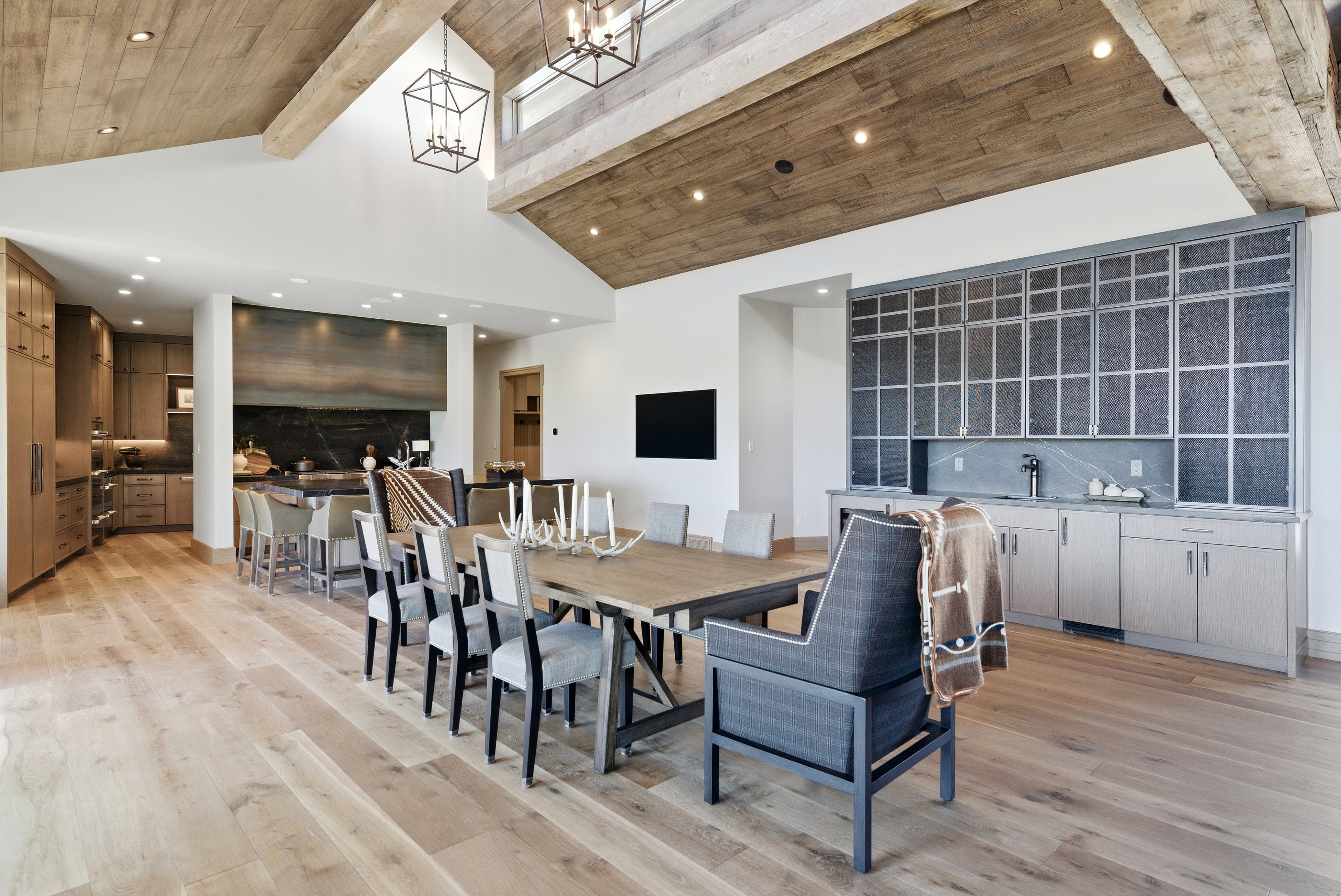 Vaulted ceilings with exposed wood beams and recessed lighting