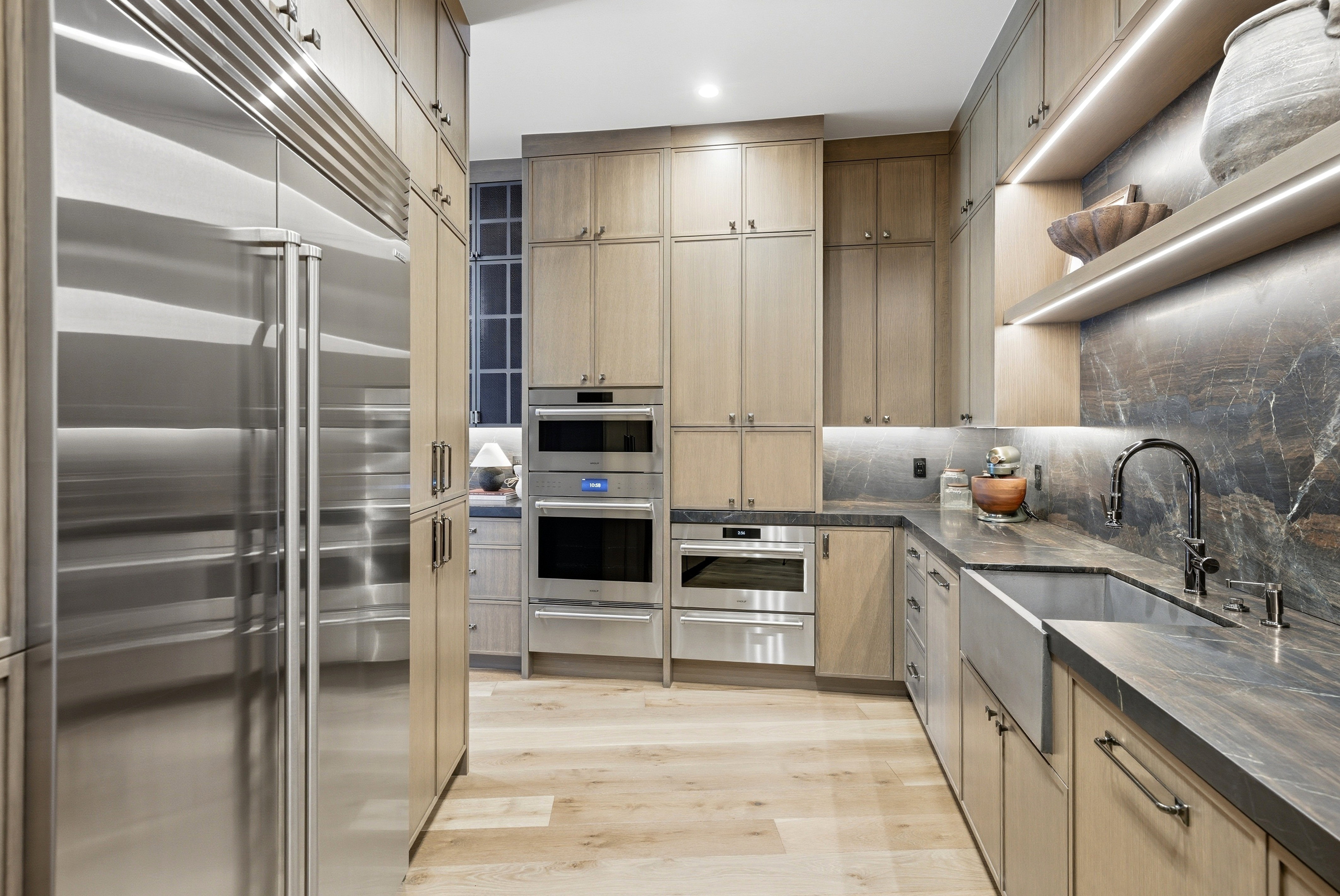 Gourmet kitchen featuring a stainless steel refrigerator, integrated double ovens, and a built-in microwave