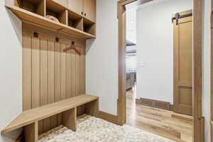Built-in wood-finish mudroom cabinetry with cubbies and storage