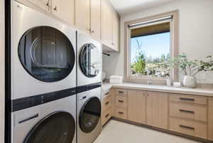 Light wood-finish cabinetry with dark hardware