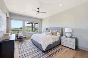 Expansive windows frame the outdoor scenery, complementing the light wood-finish flooring