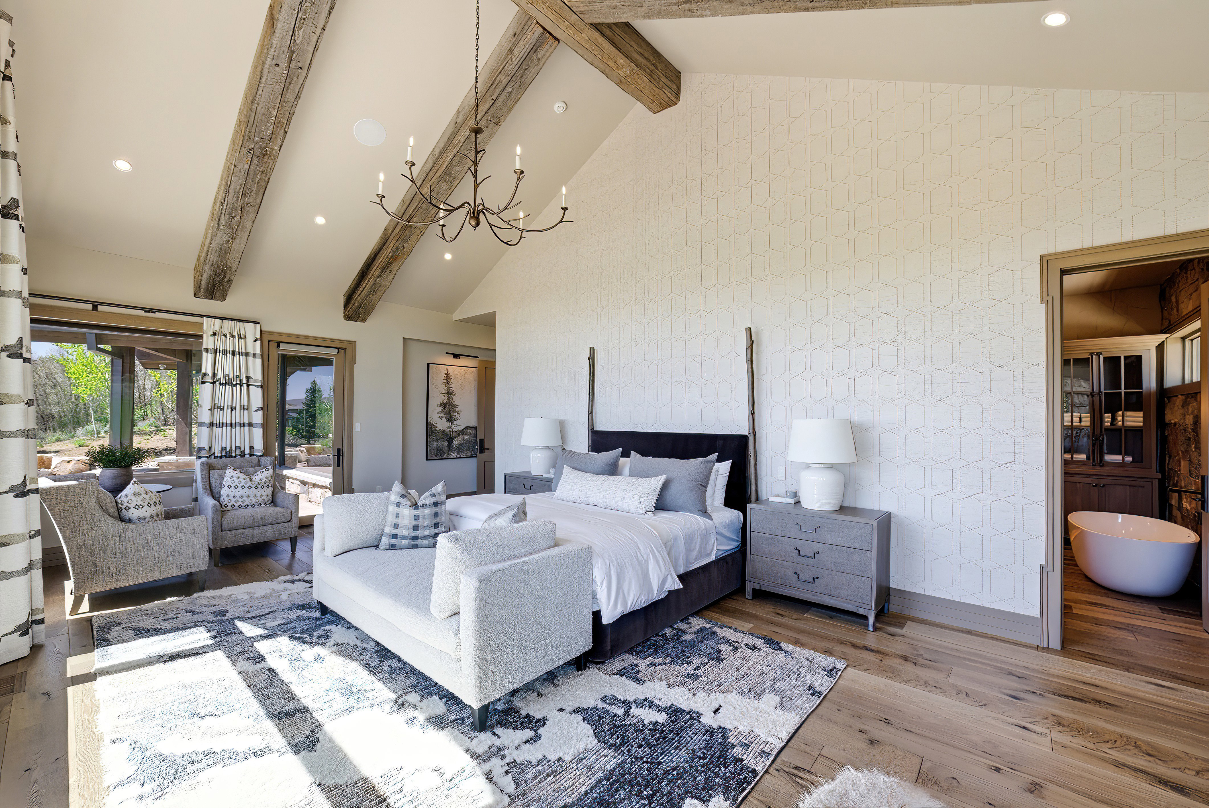 Vaulted ceiling featuring exposed wood beams and a chandelier