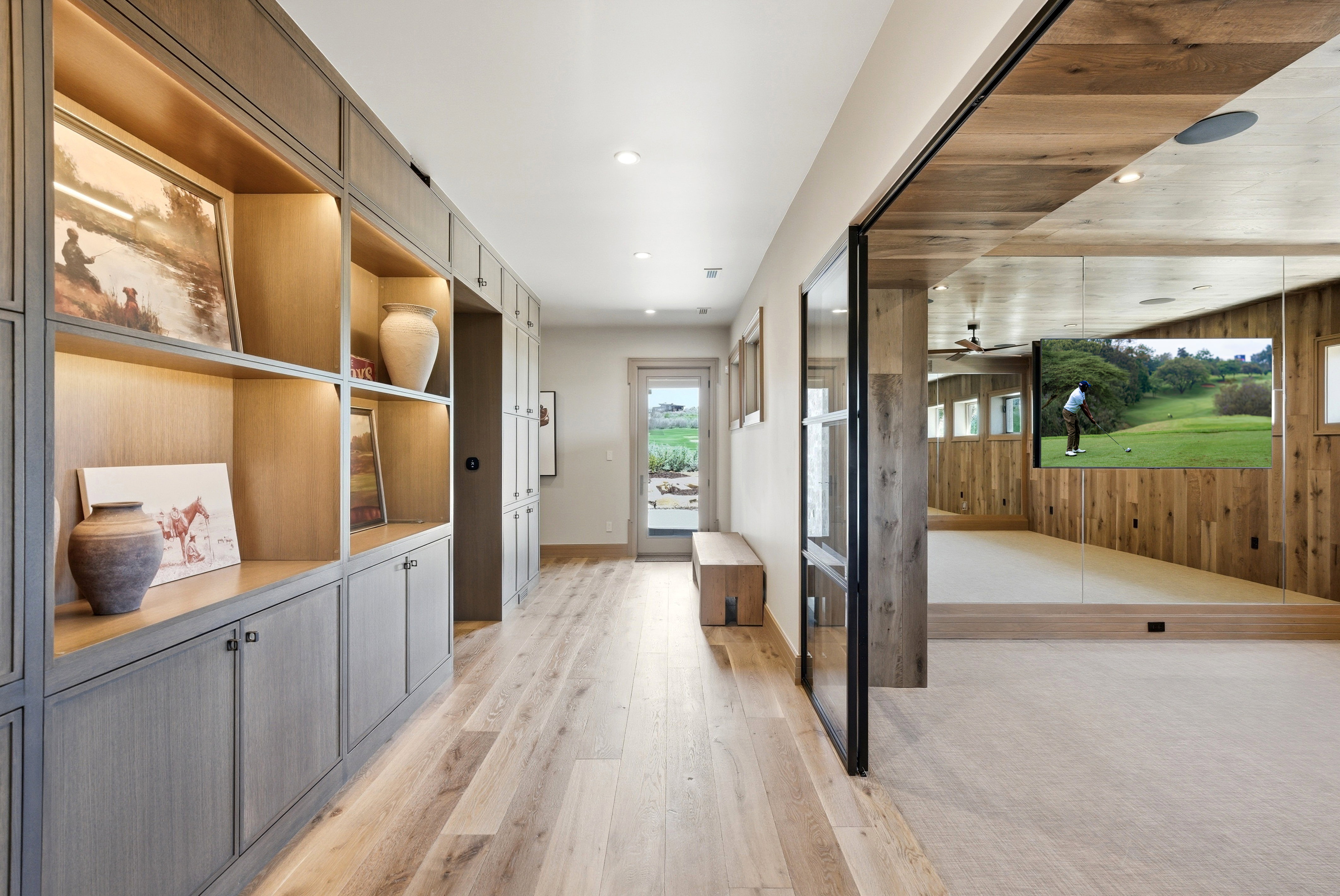 Hallway with extensive built-in cabinetry, wood-finish flooring, and recessed lighting