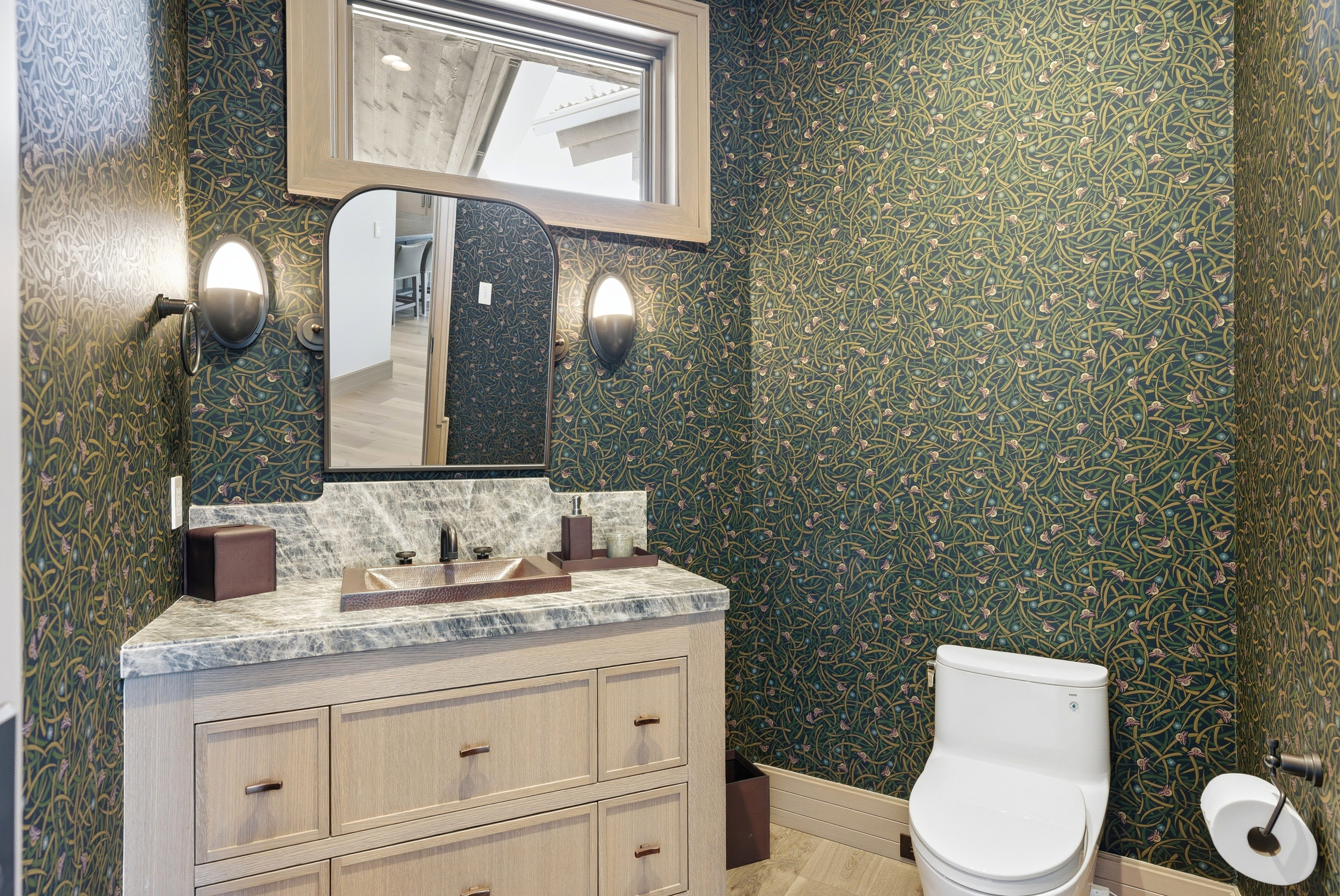 Powder room featuring a custom vanity with a stone countertop, a vessel sink, and a framed mirror